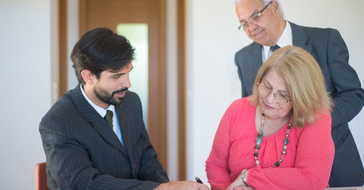 Senior couple reviewing and signing planning documents