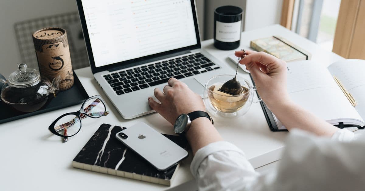 Laptop, tea, and paperwork in a comfortable home office